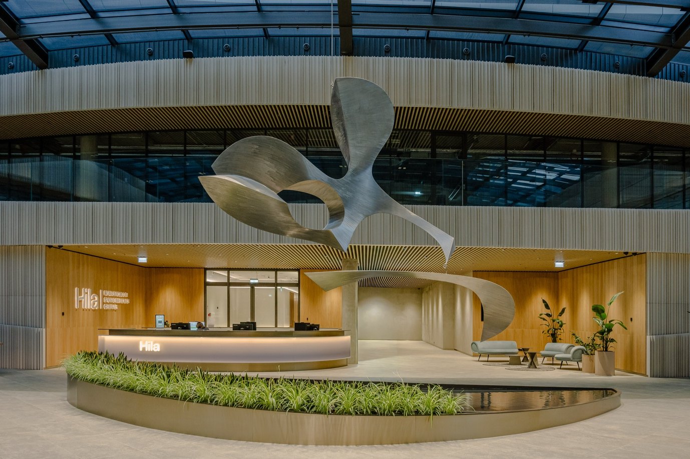Atrium of Business Stadium Central with a suspended sculptural installation above the planting