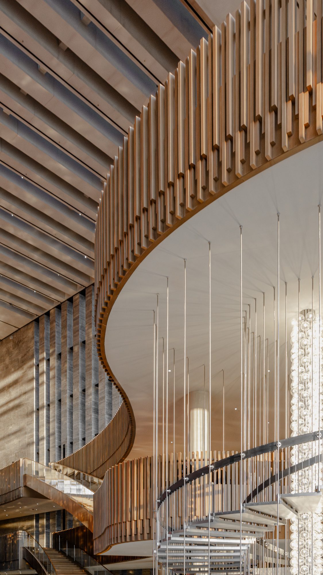 Oak-clad spiral ramp and suspended rods in the AKM atrium