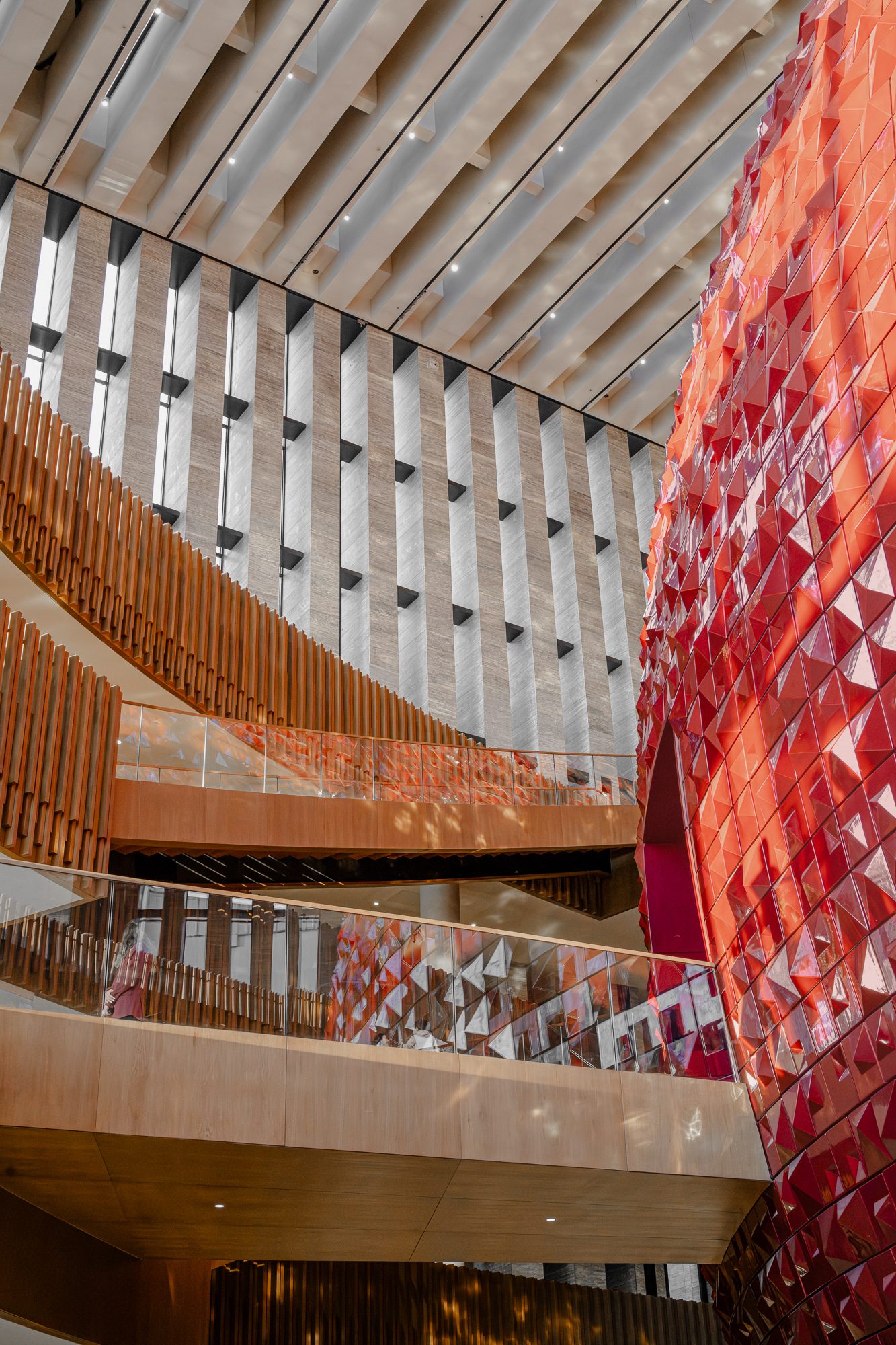 Red drum and glass balustrades beneath the slatted ceiling, AKM
