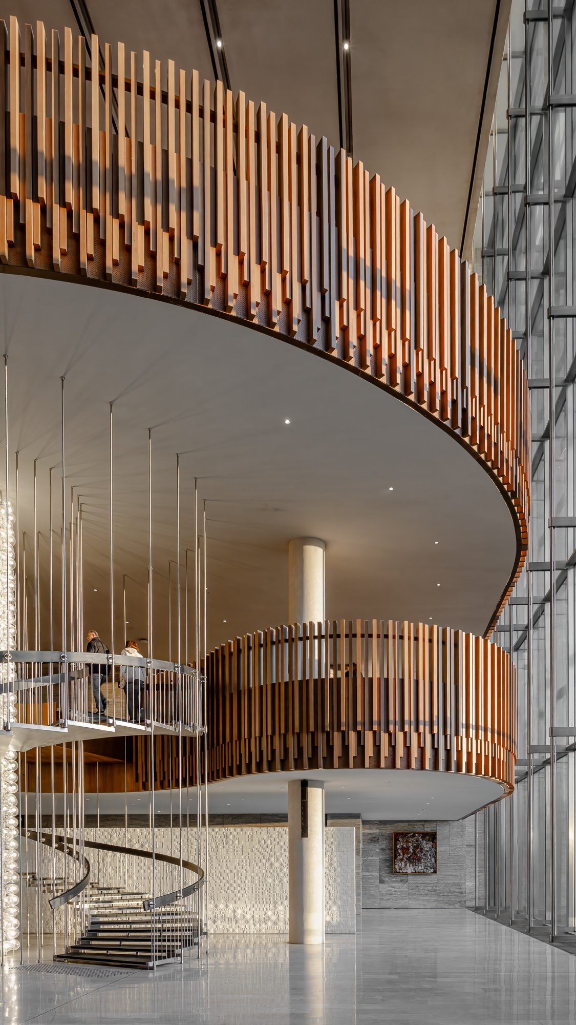 Oak-slatted balcony and spiral stair in the AKM atrium