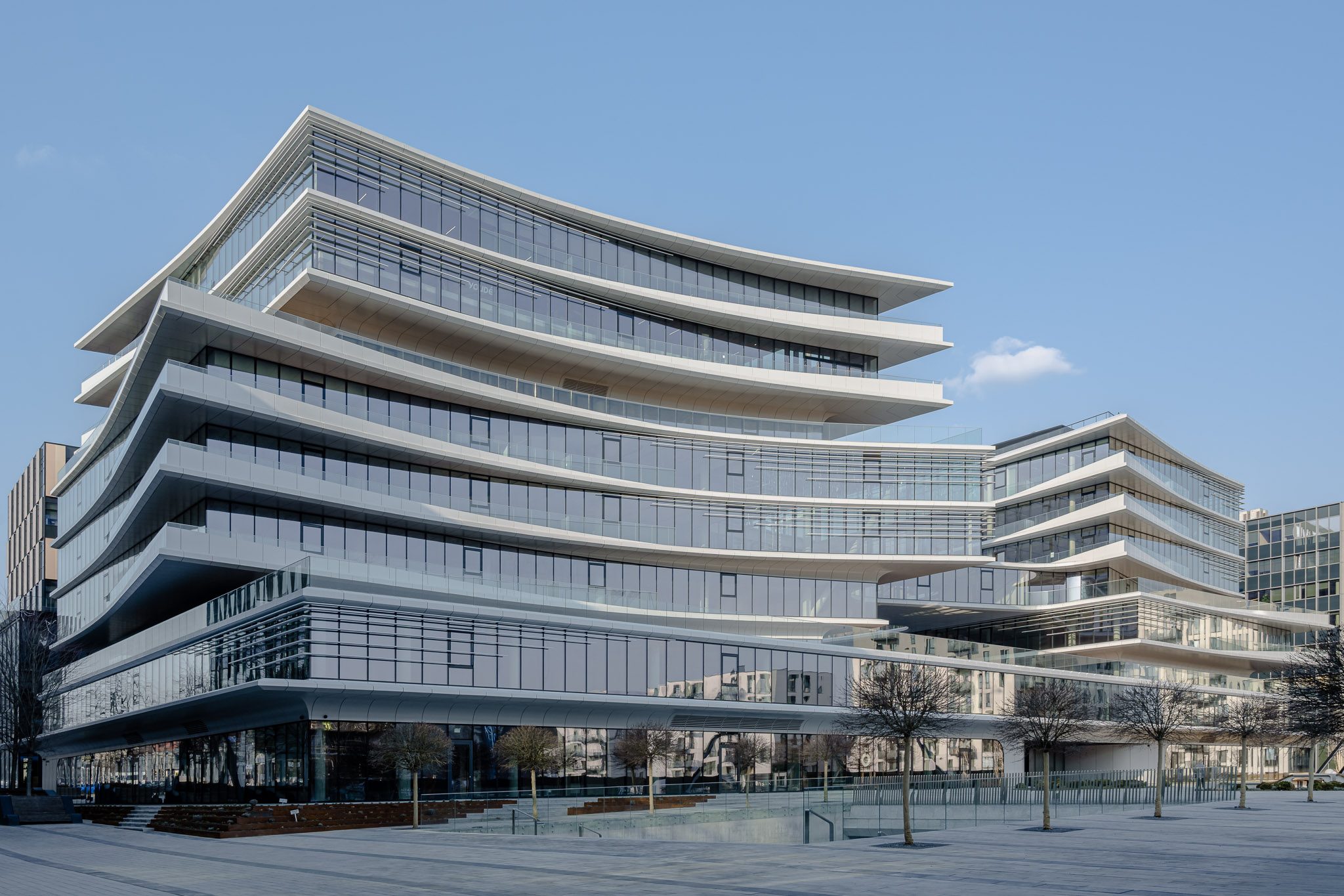 Curved, layered façade of Business Stadium Central by Zaha Hadid Architects, Vilnius