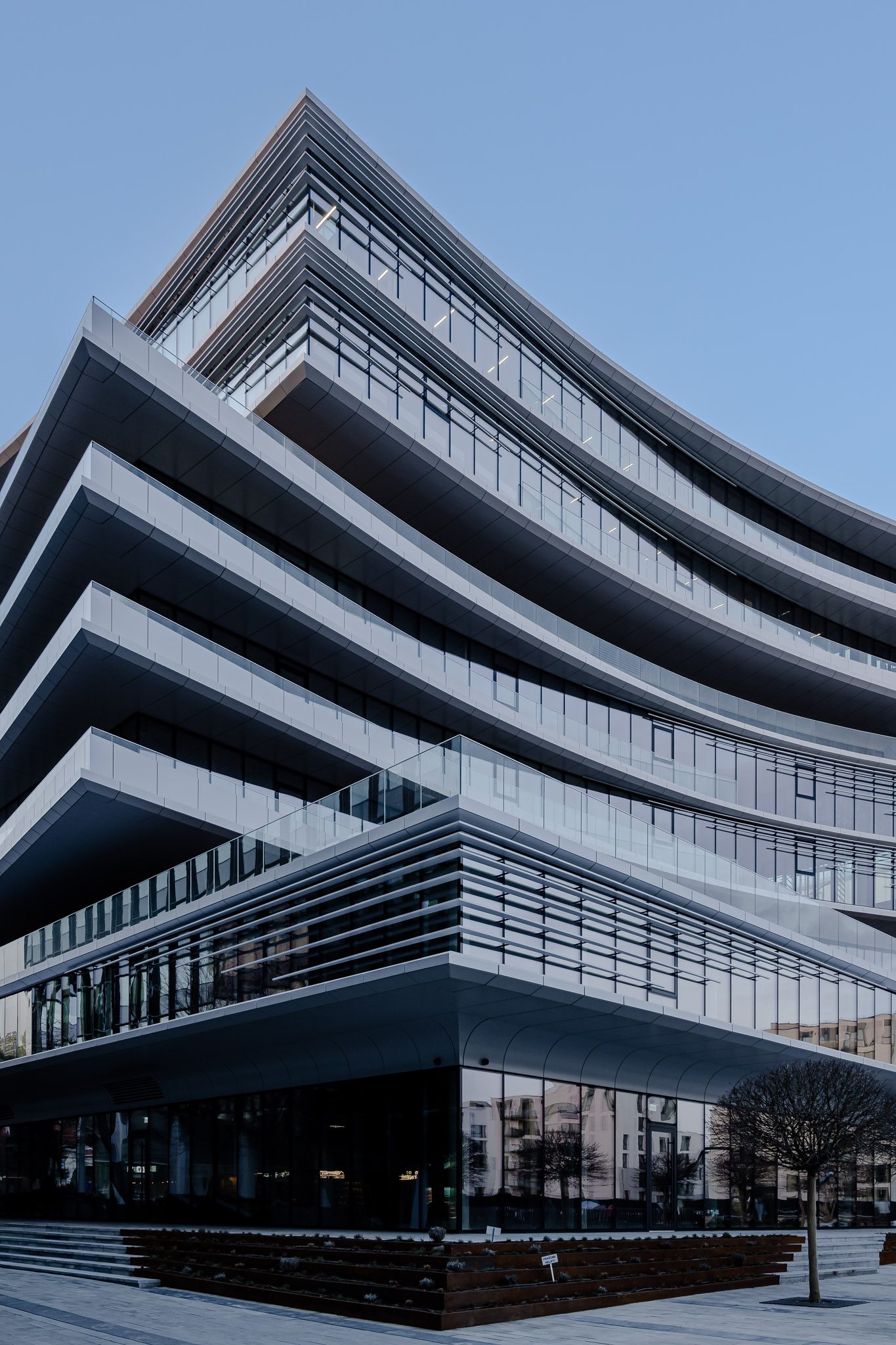Sharp corner of Business Stadium Central with stacked, curving balconies