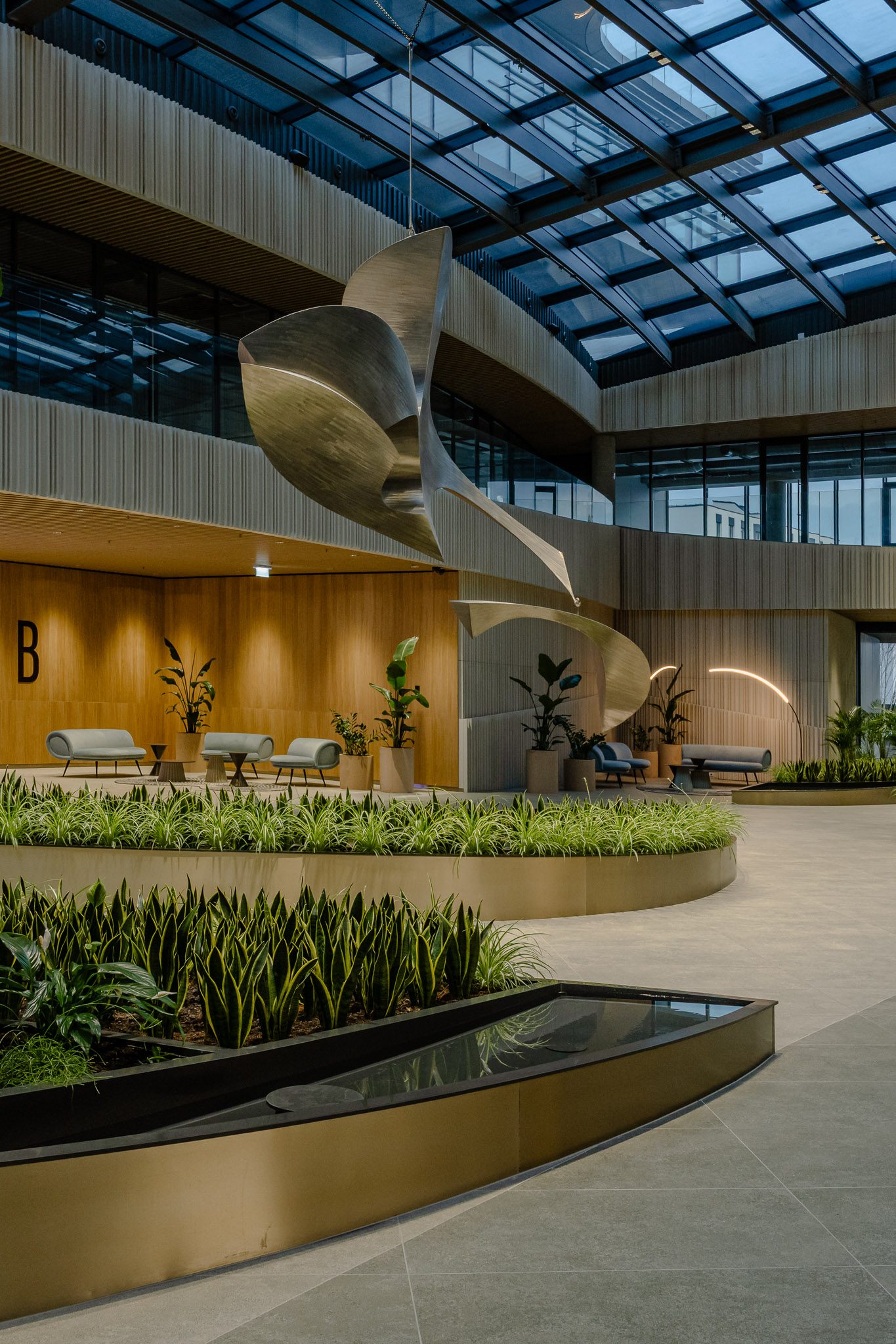 Atrium with suspended steel sculpture above the planters, Business Stadium Central