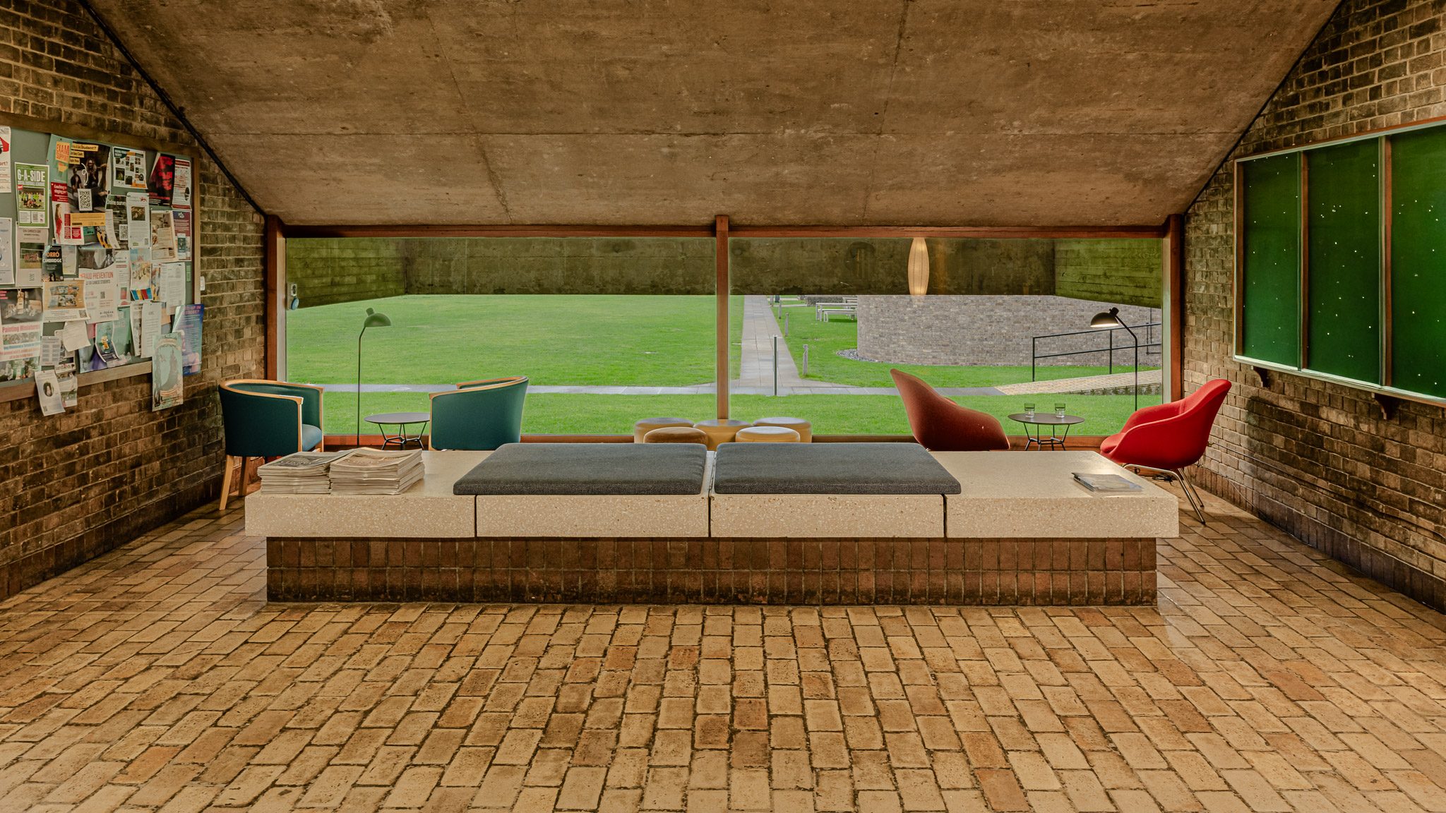 Common room with modernist chairs and views of the lawn, Churchill College