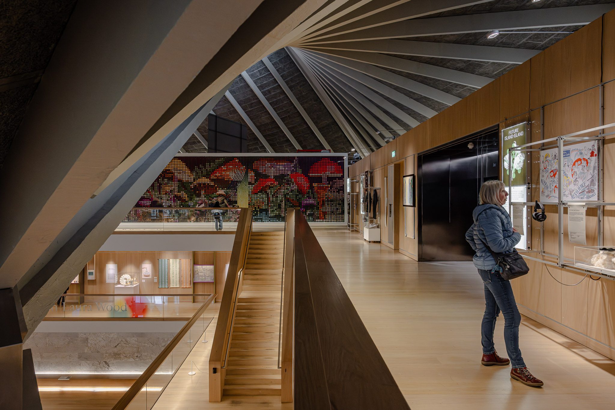 Visitor at a gallery edge under the hyperbolic paraboloid roof, Design Museum