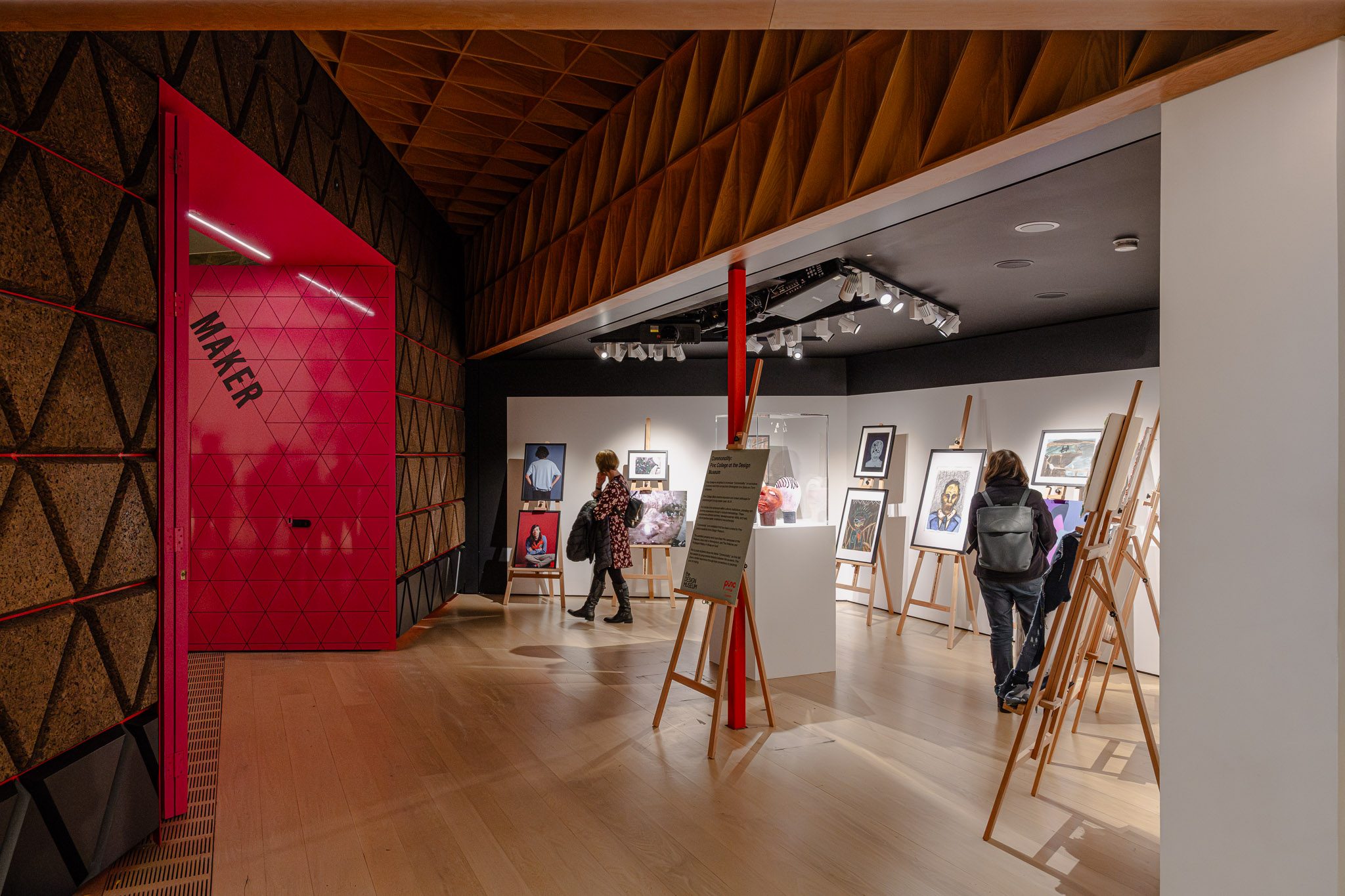 Red “Maker” panel and easels in a gallery, Design Museum