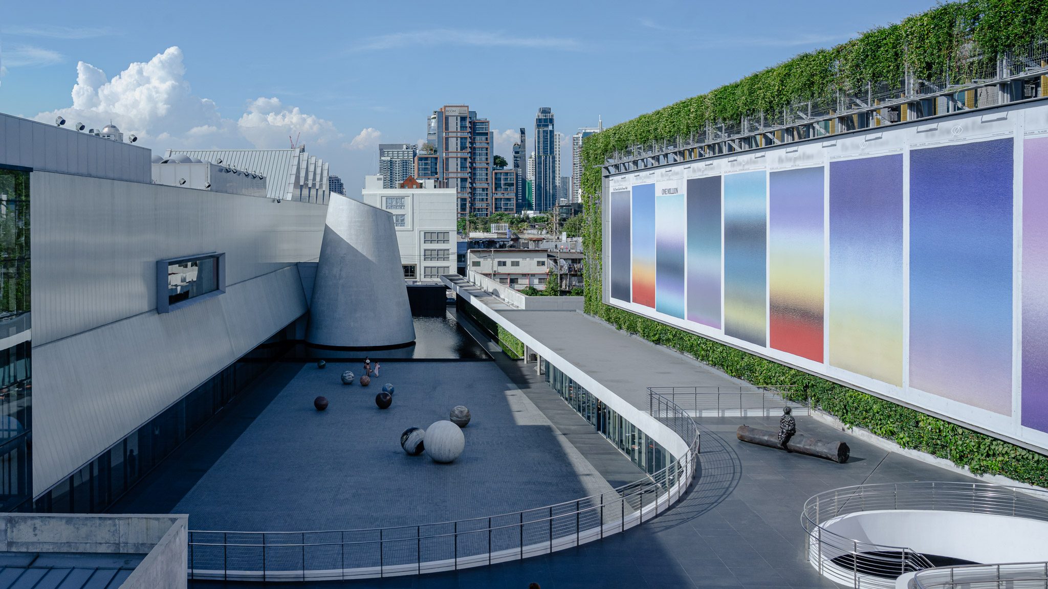 Courtyard with stone spheres and gradient façade artwork, Dib Bangkok
