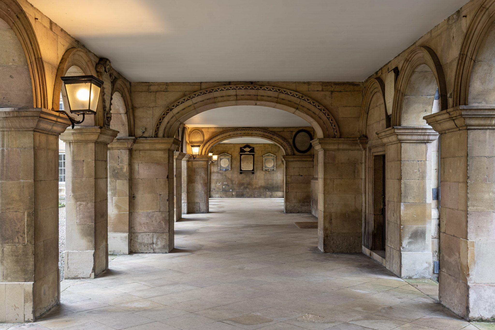 Stone colonnade with lanterns, Emmanuel College