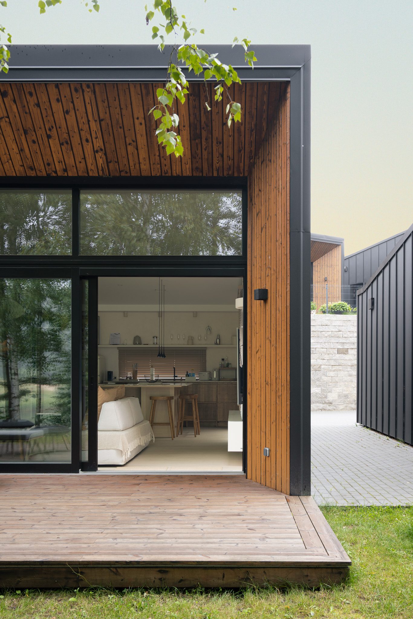 Glazed corner opening onto a timber deck, Forest Edge House
