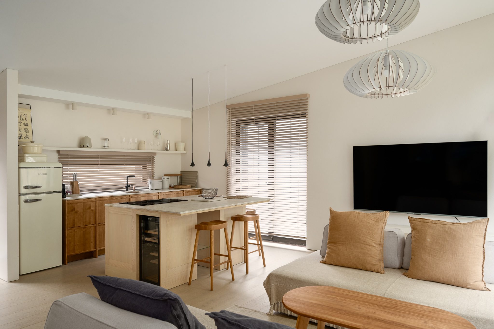 Open-plan kitchen and living room with pendant lights, Forest Edge House