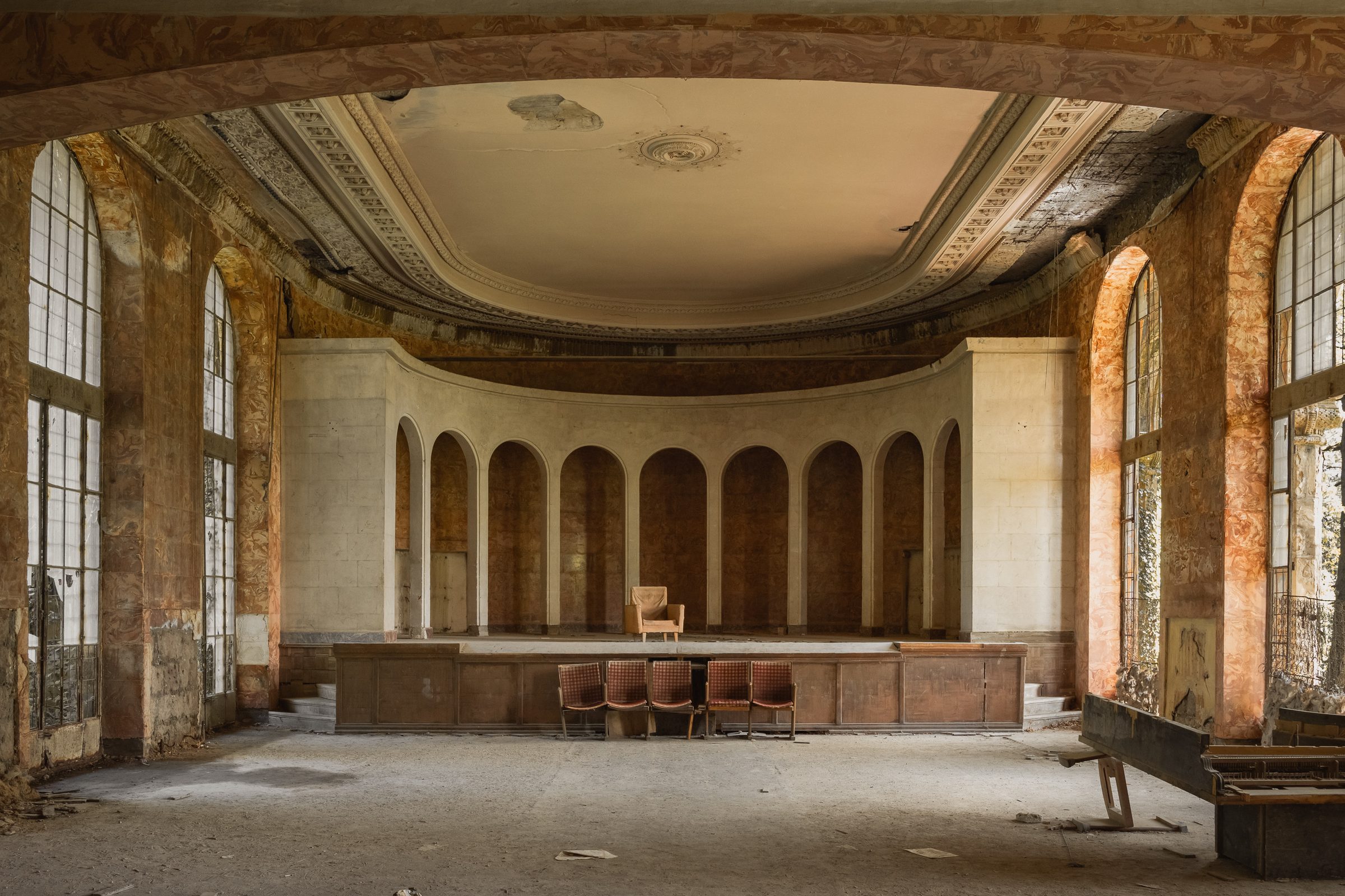 Chairs on the stage of the abandoned auditorium, Sanatorium Metallurgist, Tskaltubo — from The Last Sitting
