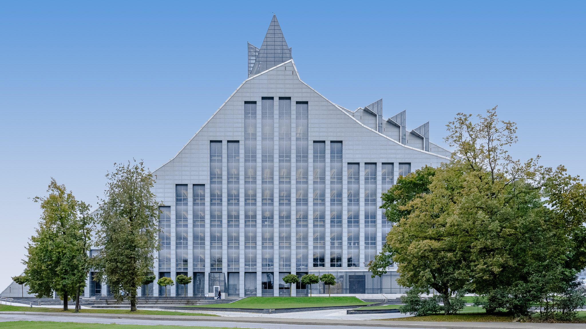 Front elevation of the National Library of Latvia framed by trees