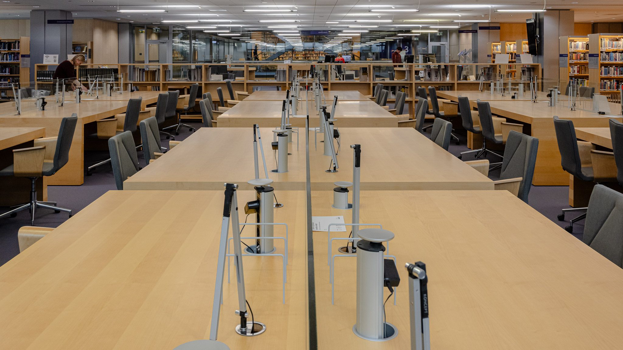 Reading room with long timber tables and lamps, National Library of Latvia