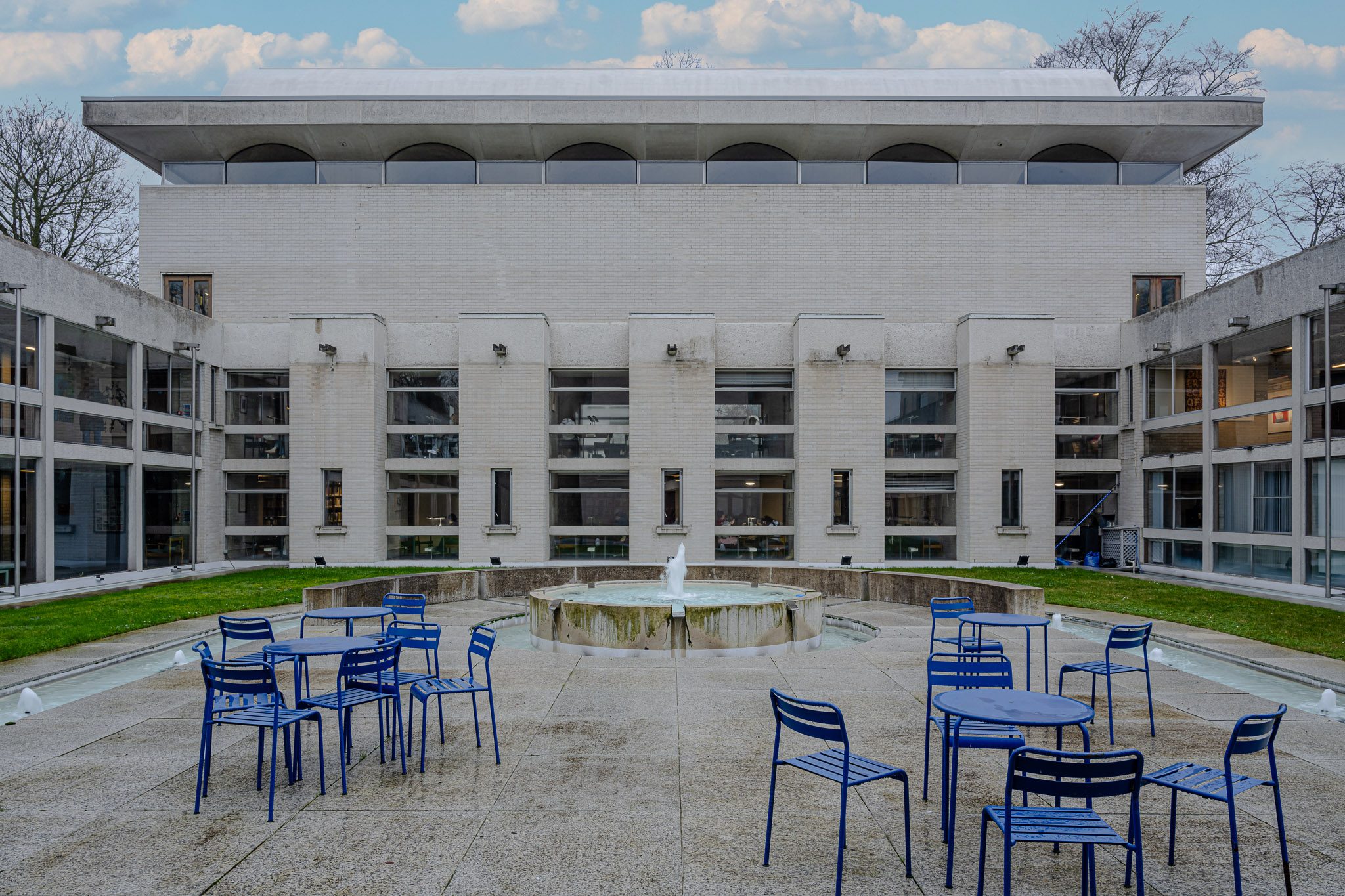 Courtyard with blue tables beside the fountain, Murray Edwards College