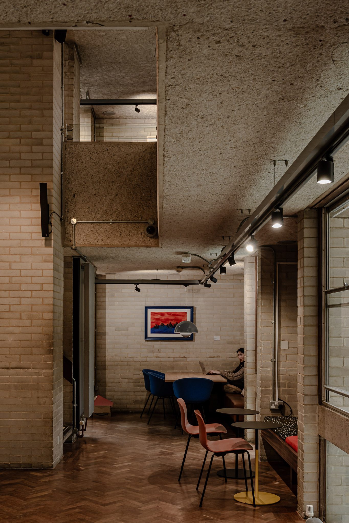 Café corner in a brick and concrete interior, Murray Edwards College