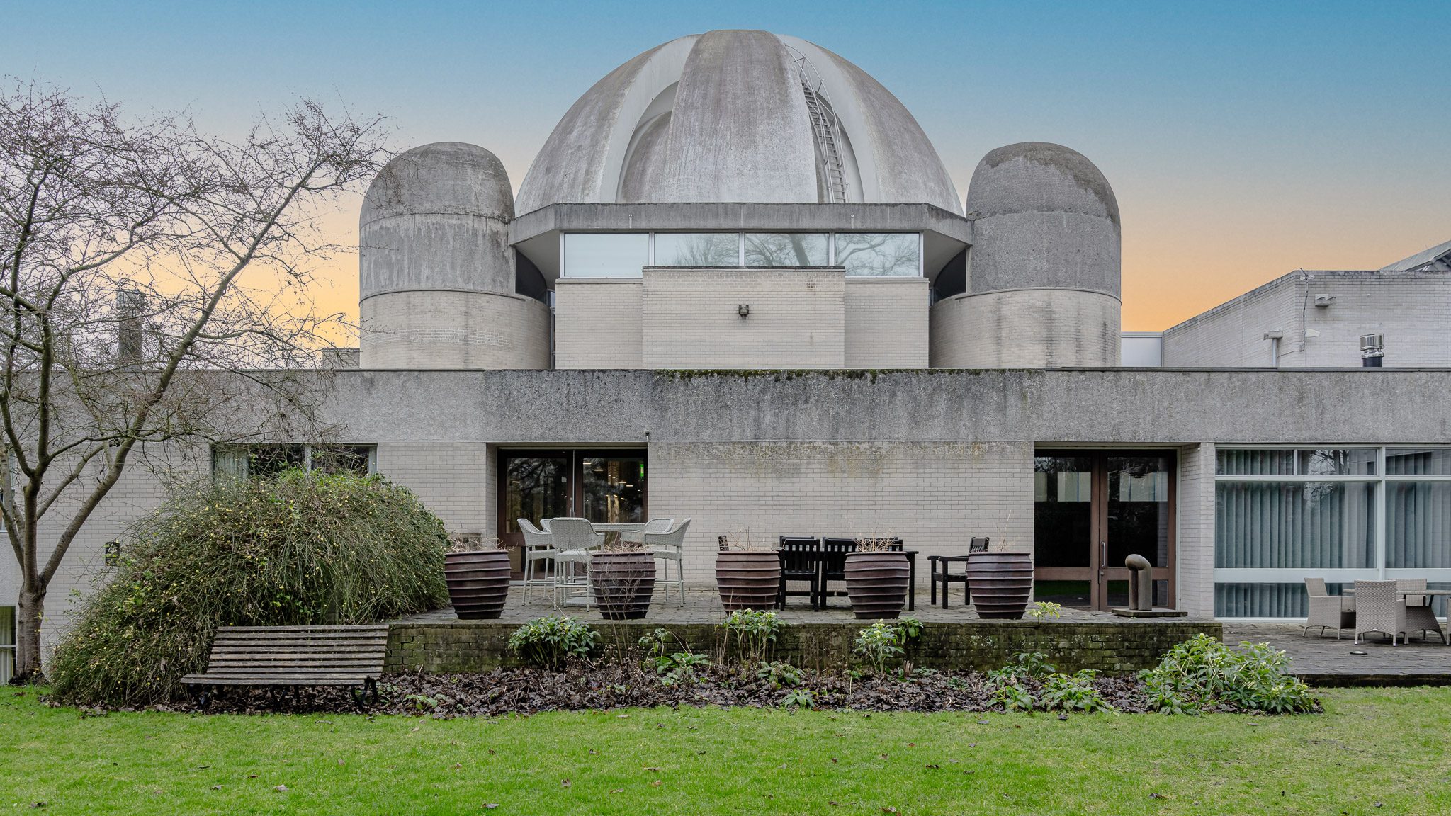 Dome and garden terrace of Murray Edwards College at dusk