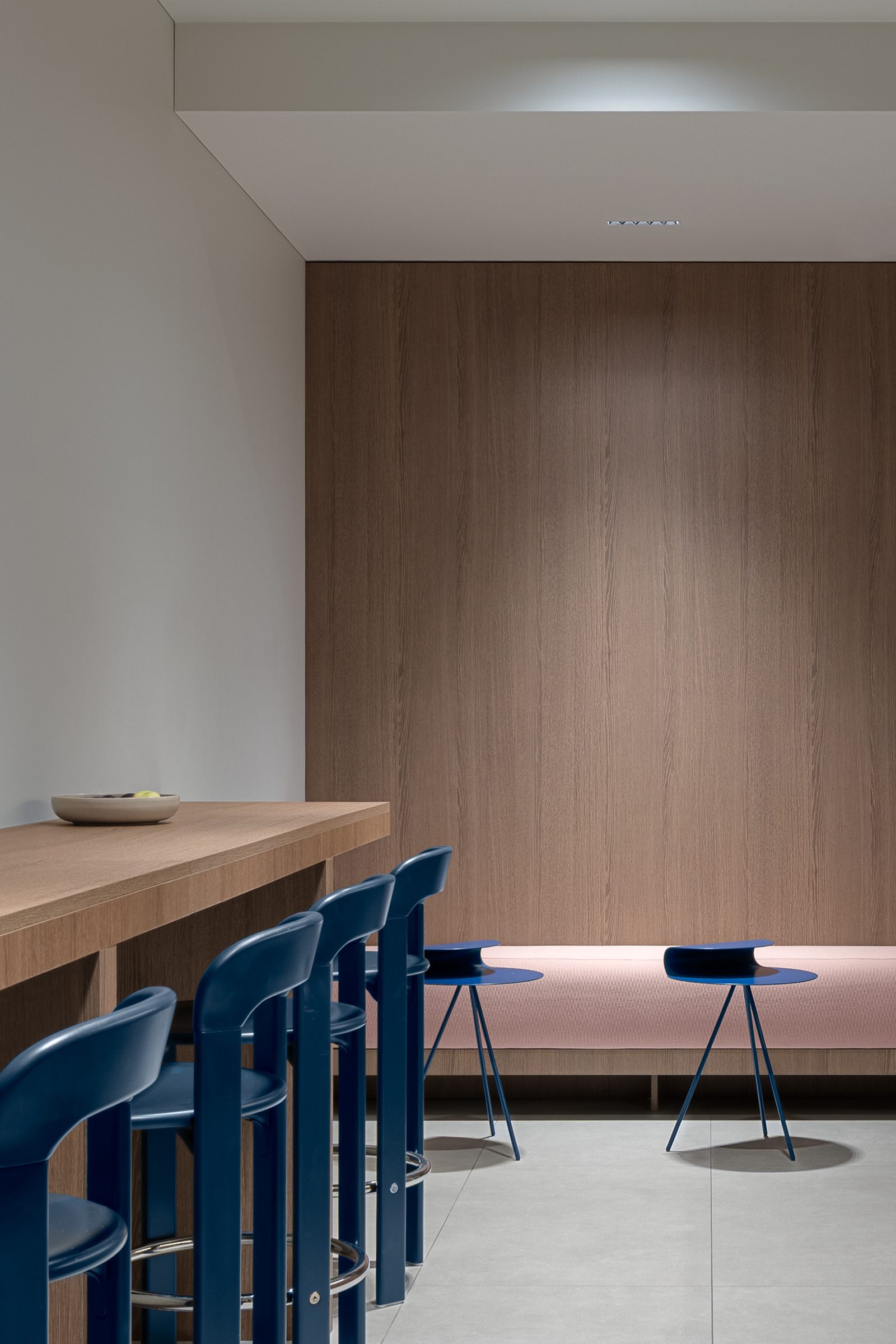 Kitchen bar with blue stools and a pink bench, Red Bull office
